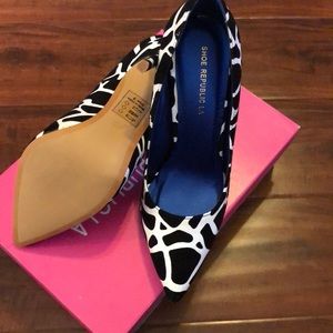 Black and white heels never worn. New with box